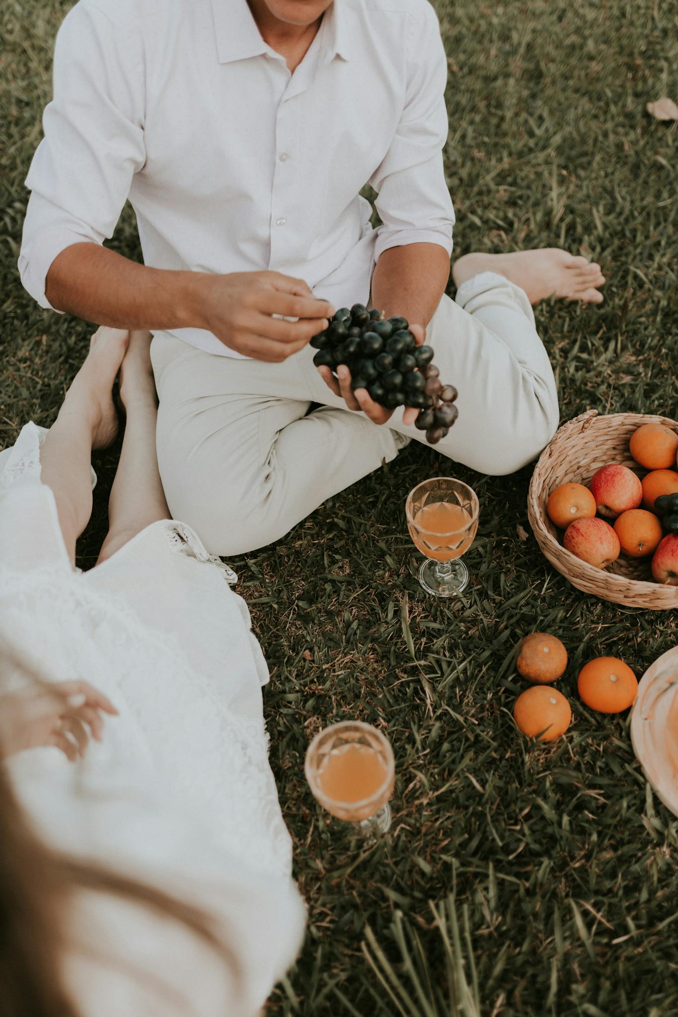 Woman and Man Sitting at Picnic on Field